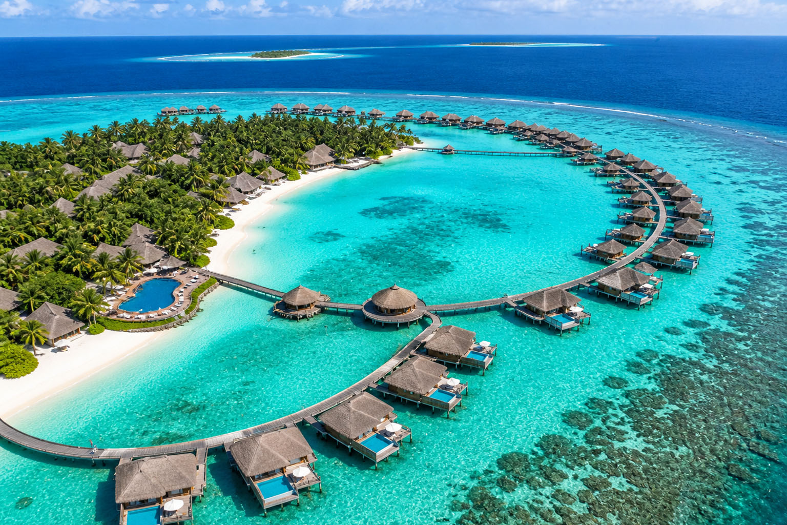 Aerial view of Maldives resort with overwater villas from Bangalore package