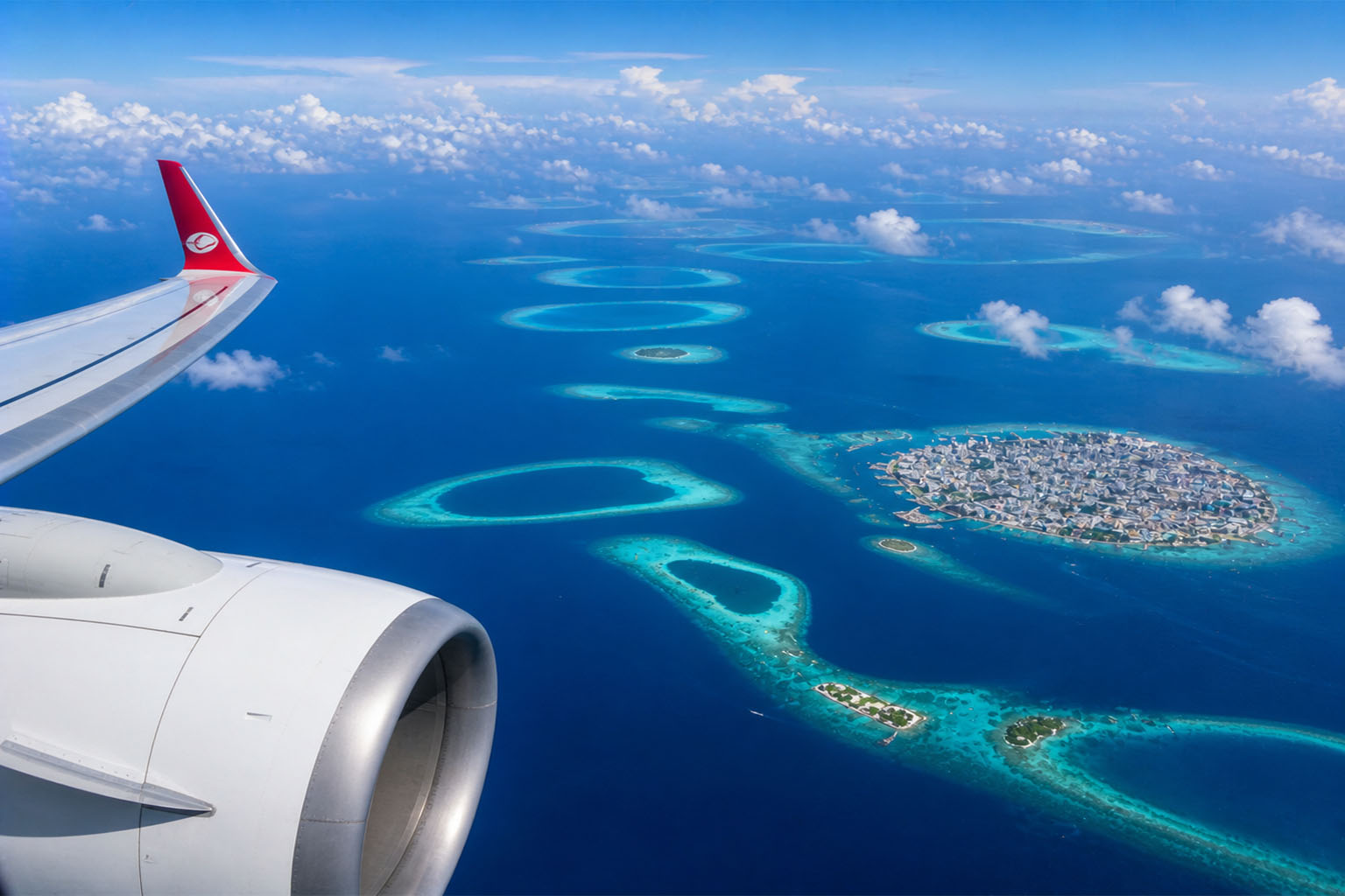 Chennai to Maldives direct flight over the Indian Ocean — aerial view of Malé atolls