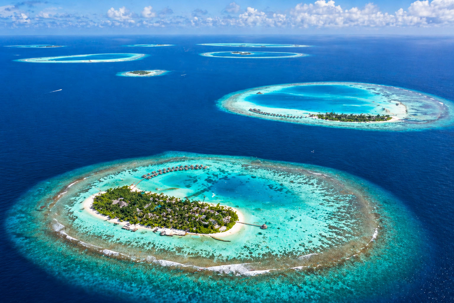 Aerial view of Maldives atolls and turquoise waters from Hyderabad to Maldives flight route
